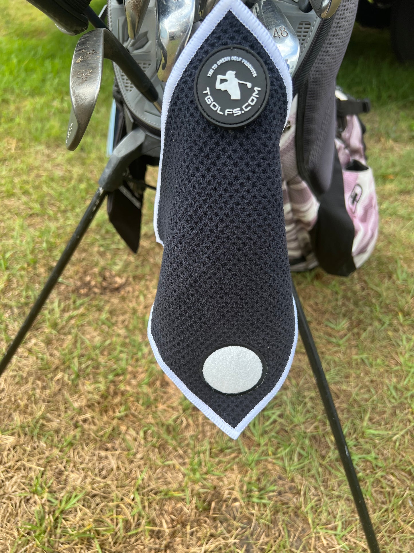Golf towel hanging from golf cart bag 
